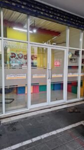 Sticker Sandblast custom logo Coding Akademi Robotics and Coding Center pada kaca fasad toko di Bali