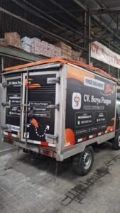 Sticker Print branding CV. Surya Pangan Food Distributor pada bak belakang mobil pickup di Bali
