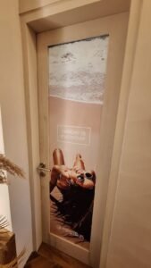 Sticker Print full door branding MegaSun tanning salon dengan tagline Tanday is Everyday di Bali