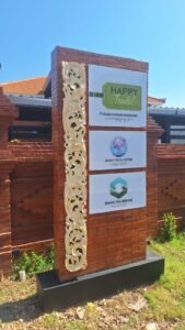 Sticker print logo Happy Trails Jambix Travel System dan Senang Eco Services pada papan nama